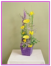 Purple and Yellow Gerbera, Freesia, Iris and Larkspur Easter Arrangement