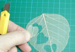 cutting small hearts from skeleton hearts