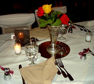 Rose blooms adding flair to a wedding reception dinner table
