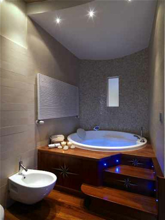 Master bathroom with built-in blue lights in the wooden steps