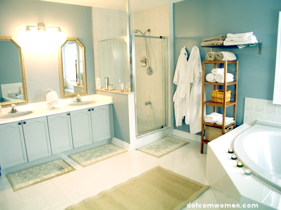 blue bathroom with ornate mirrors and fluffy towels and robes