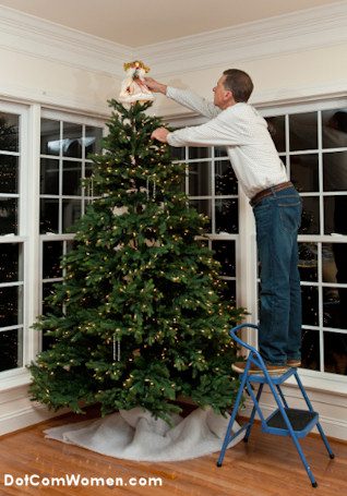 Christmas tree decorating using step ladder