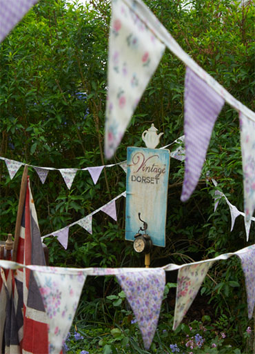 British Garden with Bunting and Wooden Signs - Summer gardening ideas